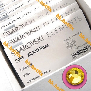 May include: A close-up of a package of Swarovski Xilion Rose Citrine (249) crystals. The package is white with black text and a barcode. The crystals are foiled and come in a gross of 1,440 pieces.