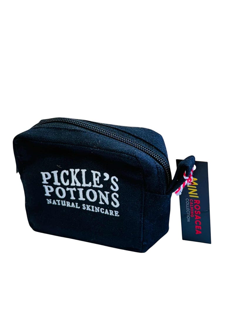 May include: A black zippered cosmetic bag with the text "PICKLE'S POTIONS NATURAL SKINCARE" in white. A small tag reads "MINI ROSACEA CALMING COLLECTION". The bag has a small loop attached to the zipper.