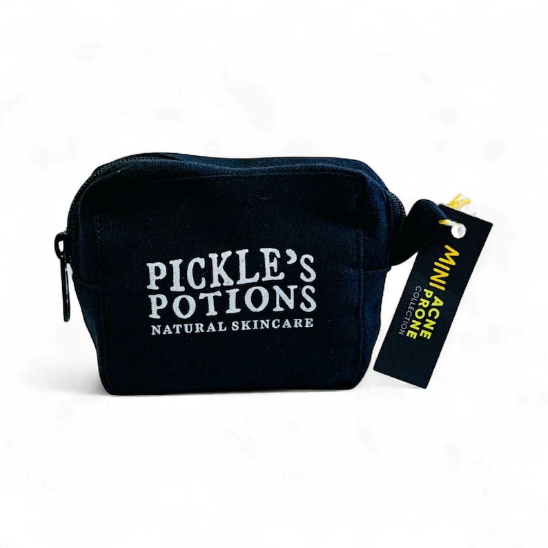 May include: A small, black cosmetic bag with a zipper closure. The bag features the text "PICKLE'S POTIONS NATURAL SKINCARE" in white. A small tag attached reads "MINI ACNE PRONE COLLECTION".