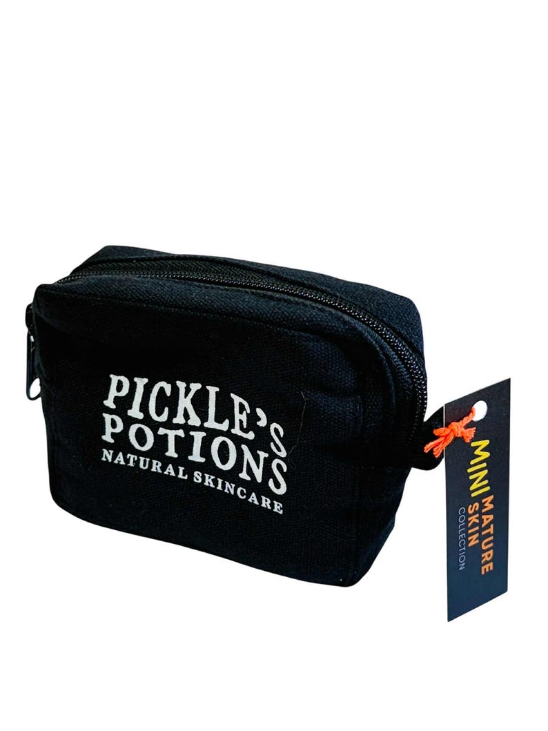 May include: Black zippered cosmetic bag with the text "PICKLE'S POTIONS NATURAL SKINCARE" in white. A small tag attached reads "MINI MATURE SKIN COLLECTION". The bag is rectangular and appears to be made of canvas.