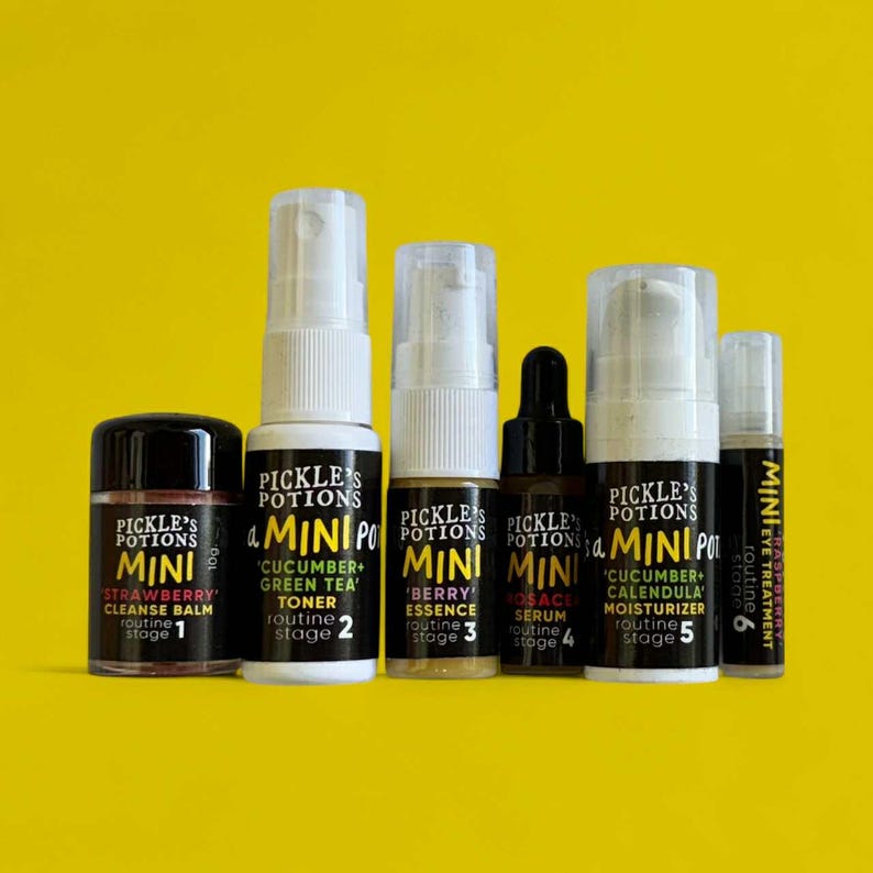 May include: A collection of six mini skincare products from Pickle's Potions, arranged on a yellow background. The products include a cleanse balm, toner, essence, serum, moisturizer, and eye treatment. Each product is labeled with its name and stage in a skincare routine.