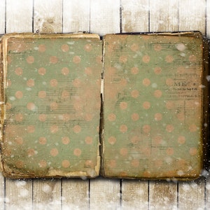 May include: An open vintage book with a green cover and a polka dot pattern. The book is lying on a wooden surface with a snowy background.