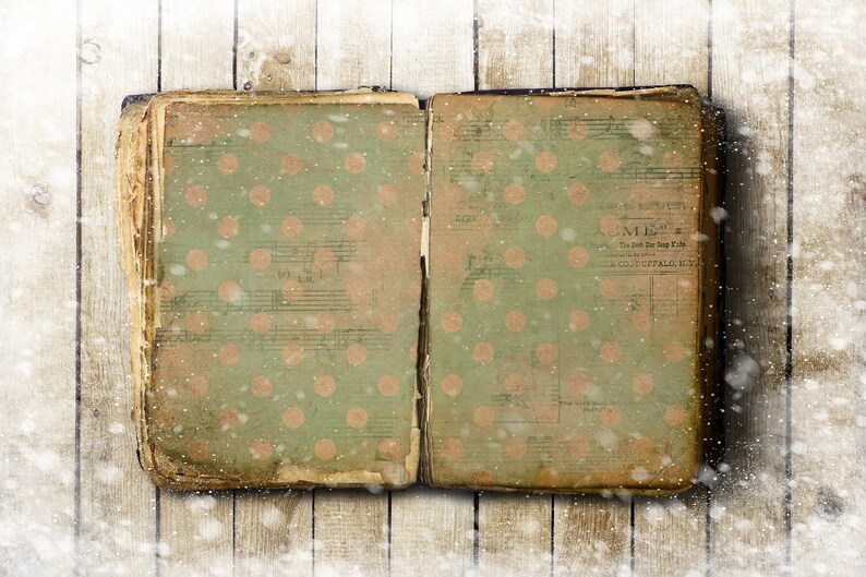 May include: An open vintage book with a green cover and a polka dot pattern. The book is lying on a wooden surface with a snowy background.