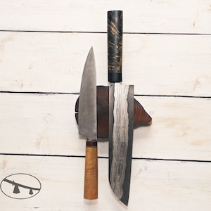 May include: Two kitchen knives with wooden handles are mounted on a wooden block. The knives have different blade styles and are made of metal with a black and silver finish.