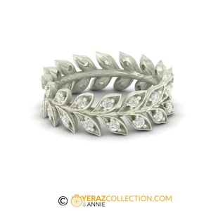 May include: A silver ring with a delicate design of leaves and small diamonds.