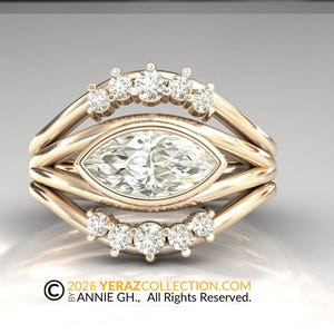 May include: A three-piece gold ring set. The center ring features a marquise-cut diamond, flanked by two bands, each adorned with smaller diamonds. The rings are set against a soft, reflective background. The text "© 2026 YERAZCOLLECTION.COM BY ANNIE GH., All Rights Reserved." is visible.