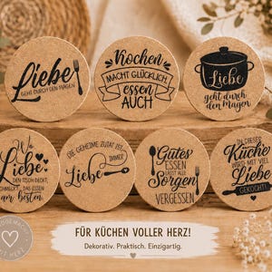 May include: A set of seven round cork coasters featuring black printed German text and kitchen-themed illustrations including a cooking pot, fork, spoon, and rolling pin. Each coaster displays unique phrases about love and cooking in a decorative font.