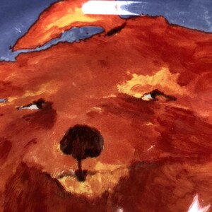 May include: A watercolour painting of a bear's face, in shades of orange and red. The bear has a black nose and small, dark eyes. The background is a mix of blue and orange.