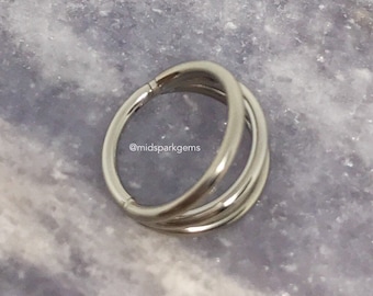 Puede incluir: Anillo de nariz triple aro de plata. El anillo está hecho de tres aros apilados uno encima del otro. El anillo es una opción popular para piercings de nariz.