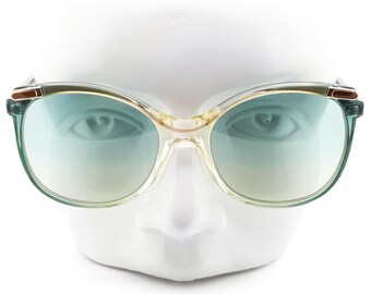 May include: A pair of green and gold-rimmed sunglasses with a gradient blue lens.