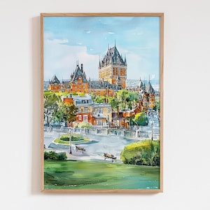 May include: Watercolor painting of a cityscape featuring a large, ornate building with multiple towers and a complex roofline. The buildings are primarily orange and brown, set against a blue sky. The artwork is framed in a light-colored wooden frame.