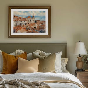 Lisbon_Alfama_watercolor_painting_on_the_wall_above_the_bed_in_a_bedroom_with_green_walls_white_and_brown_bedding