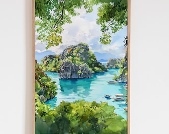 May include: Watercolour painting of a tropical bay with turquoise water, lush green islands, and small boats. The artwork is framed in a light brown wooden frame, with green foliage in the foreground and a cloudy sky.