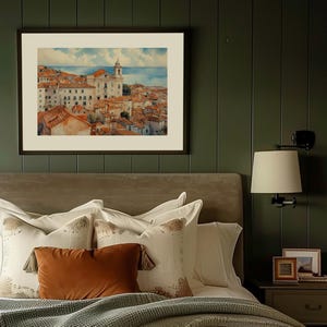Lisbon_Alfama_watercolor_painting_hangs_above_an_antique_beige_velvet_bed_with_brown_and_white_pillows