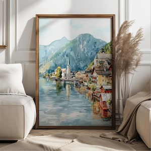 Peut inclure: Peinture &agrave; l'aquarelle d'un village au bord d'un lac avec une &eacute;glise et des montagnes en arri&egrave;re-plan. L'&oelig;uvre est encadr&eacute;e dans un cadre en bois fonc&eacute; et est expos&eacute;e &agrave; l'int&eacute;rieur. La peinture pr&eacute;sente une vari&eacute;t&eacute; de couleurs, dont le bleu, le vert, le jaune et le rouge.