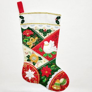 May include: A red, green, and white Christmas stocking with a patchwork design. The stocking is decorated with embroidered flowers, a dove, and bells.