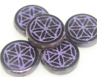 May include: Five round purple glass beads with a black geometric design. The beads have a shiny, iridescent finish.