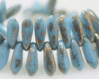 May include: A strand of light blue glass beads with gold flecks. The beads are teardrop shaped and have a rustic, vintage look.