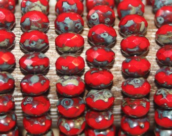 May include: A strand of red and gray glass beads with a faceted design. The beads have a mottled, marbled appearance.