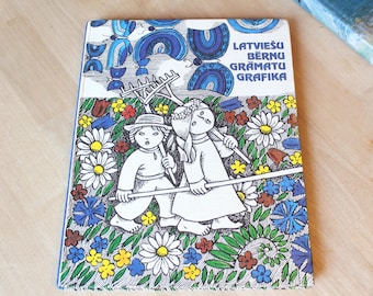 May include: A vintage children's book with a colorful cover. The cover features illustrations of two figures holding rakes, surrounded by flowers. The title text is in blue and the book has a blue border.