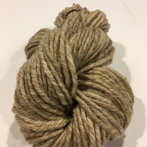 May include: A skein of brown and beige yarn, perfect for knitting or crocheting.