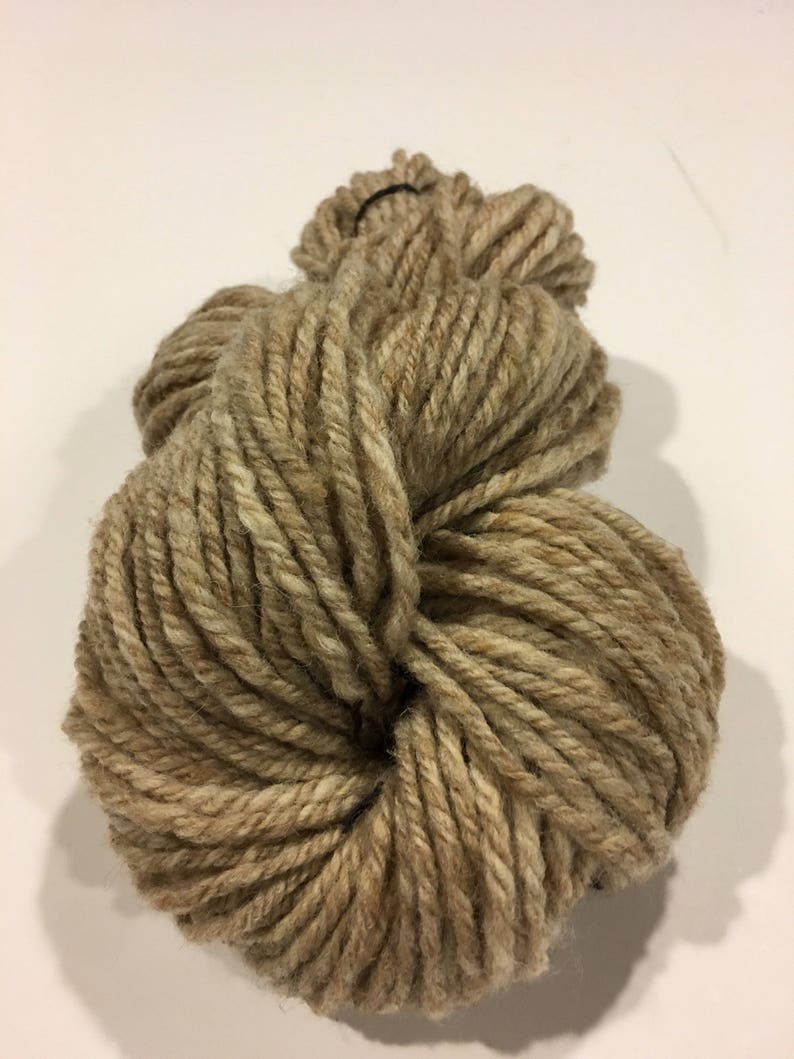 May include: A skein of brown and beige yarn, perfect for knitting or crocheting.