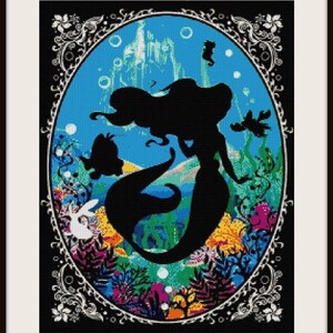 May include: A black silhouette of Ariel the mermaid from Disney's The Little Mermaid, surrounded by colorful coral and sea life. The silhouette is set against a blue background with a castle in the distance. The image is framed with a black and white ornate border.