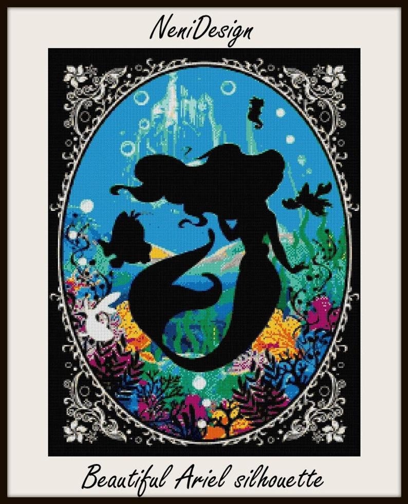 May include: A black silhouette of Ariel the mermaid from Disney's The Little Mermaid, surrounded by colorful coral and sea life. The silhouette is set against a blue background with a castle in the distance. The image is framed with a black and white ornate border.