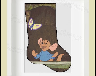 May include: Cross stitch pattern for a Christmas stocking featuring Roo from Winnie the Pooh. Roo is wearing a blue sweater and is standing in front of a tree trunk with a butterfly flying nearby. The pattern is compatible with Pattern Keeper.