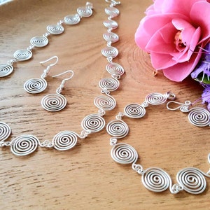 Silver spiral necklace, bracelet and earrings set in our open spiral design. Choose your silver grade - silver plate, sterling silver of fine silver. Choose your length and clasp type.