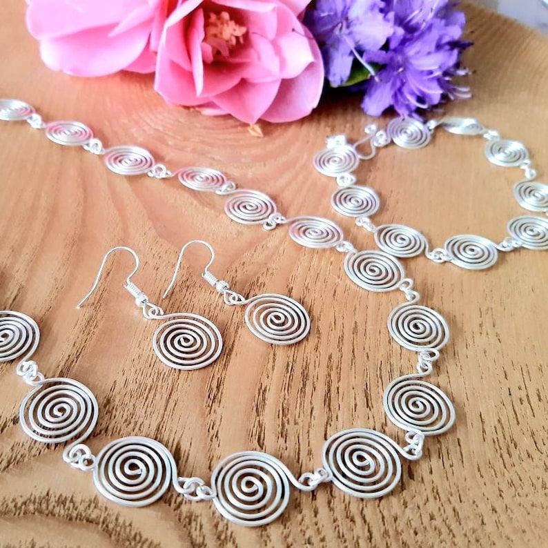 Silver spiral necklace, bracelet and earrings set in our open spiral design. Choose your silver grade - silver plate, sterling silver of fine silver. Choose your length and clasp type.