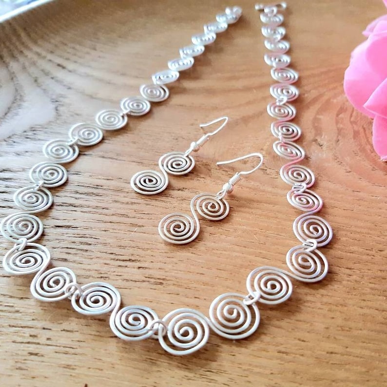 Silver spiral necklace and earrings set in our Celtic  spiral design. Choose your silver grade - silver plate, sterling silver of fine silver. Choose your length and clasp type.