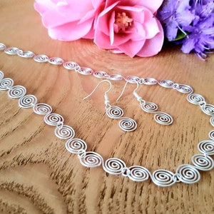 Silver spiral necklace and earrings set in our Celtic  spiral design. Choose your silver grade - silver plate, sterling silver of fine silver. Choose your length and clasp type.