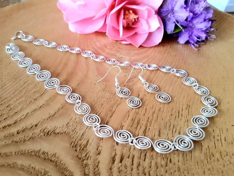Silver spiral necklace and earrings set in our Celtic  spiral design. Choose your silver grade - silver plate, sterling silver of fine silver. Choose your length and clasp type.