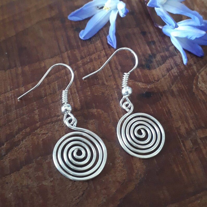 Silver spiral drop earrings, made in a choice of silver grade wires. Elegant and simple these stylish earrings can be worn for any occasion with any outfit.