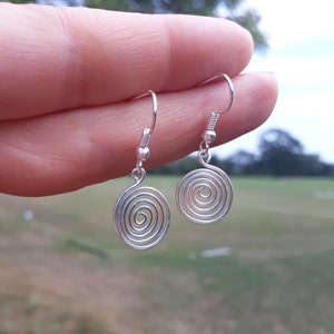 Silver spiral drop earrings, made in a choice of silver grade wires. Elegant and simple these stylish earrings can be worn for any occasion with any outfit.