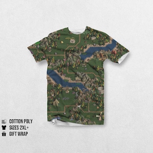 May include: A white t-shirt with a detailed fantasy map design, including rivers, forests, and buildings. The shirt is made of cotton poly and available in sizes 2XL+. The text "GIFT WRAP" is also visible.