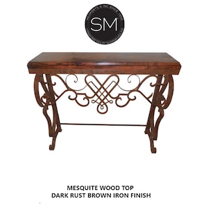 May include: A rustic console table with a dark brown mesquite wood top and a dark rust brown iron base. The iron base features a decorative scroll design.