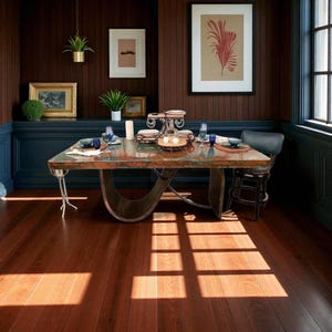 May include: A dining room with a large, rectangular copper-topped table. The table is set with dishes and glassware. The room has dark wood paneling, a dark blue accent wall, and a hardwood floor. Artwork and plants decorate the walls.
