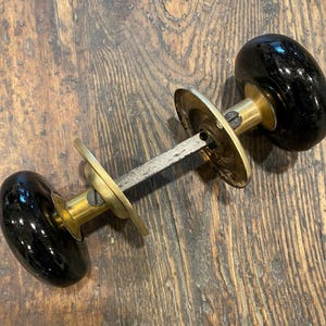 Black Porcelain Door Knobs with Brass Shanks and Rosettes.  Antique Victorian.