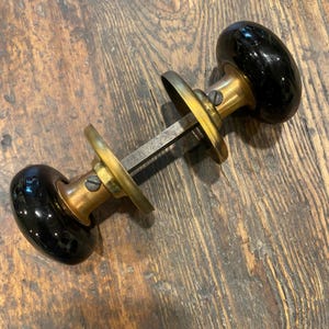 Black Porcelain Door Knobs with Brass Shanks and Rosettes.  Antique Victorian.