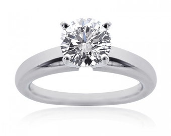 May include: A classic solitaire engagement ring with a large, round, brilliant-cut diamond set in a simple, polished band.