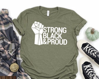 May include: A green t-shirt with a white raised fist and the text "Strong Black & Proud".