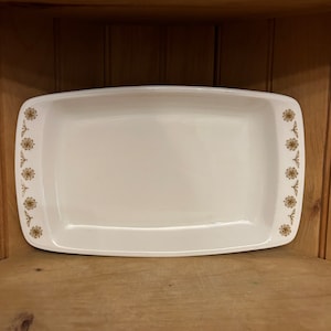 May include: White rectangular baking dish with a gold floral pattern around the edge.