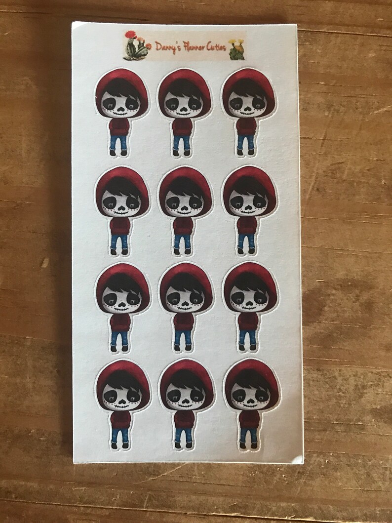 May include: Sheet of stickers featuring a cartoon character with a skull face, wearing a red hooded sweatshirt and blue jeans. The stickers are on a white background, with the text "Danny's Planner Cuties" at the top.