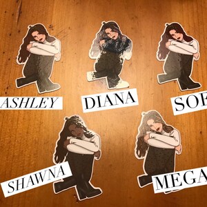 May include: Five illustrated stickers of women with different hairstyles and clothing. Each sticker has a name below it: Ashley, Diana, Sofia, Shawna, and Megan.