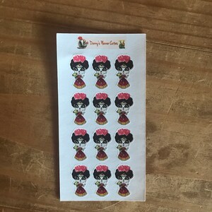 May include: A sheet of stickers featuring a stylized illustration of a woman with a floral headdress and a red dress. The stickers have a Day of the Dead theme. The text "Danny's Planner Cutters" is printed at the top.