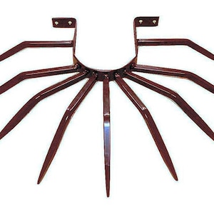 May include: A dark brown metal garden tool with multiple tines, designed for cultivating soil. The tool has a U-shaped frame with two vertical supports and a circular base.