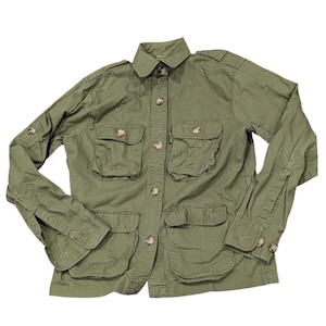 May include: Olive green jacket with multiple front pockets and button closures. The jacket has a collared neckline and buttoned cuffs. The buttons are a light brown color. The jacket is made of a durable fabric.