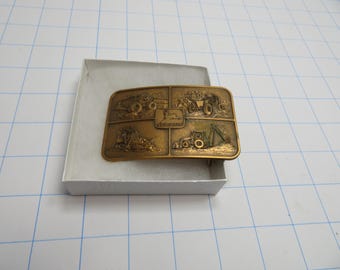 F 61 John Deere 1974 Belt Buckle Brass/Copper Tone Metal Featuring (4) Different John Deere Construction Equipment - Brand New Old Stock